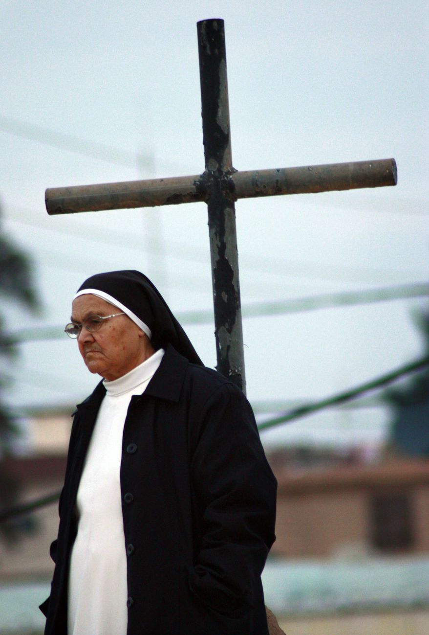 An Iraqi catholic nun is seen before Christmas Eve mass in Mosul, 360 kilometers (225 miles) northwest of Baghdad on Dec. 24, 2009. (Associated Press) **FILE**