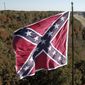 This Friday, Oct. 27, 2017 shows traffic flowing along the Route 58 bypass as a giant Confederate battle flag owned by flagger Robert Collie flutters in the breeze in Danville, Va. (AP Photo/Steve Helber)