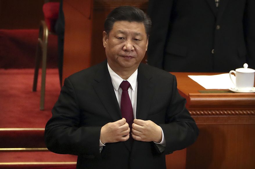 Chinese President Xi Jinping adjusts his suit coat during the closing session of the Chinese People's Political Consultative Conference (CPPCC) at the Great Hall of the People in Beijing, Thursday, March 15, 2018. (AP Photo/Mark Schiefelbein) ** FILE **