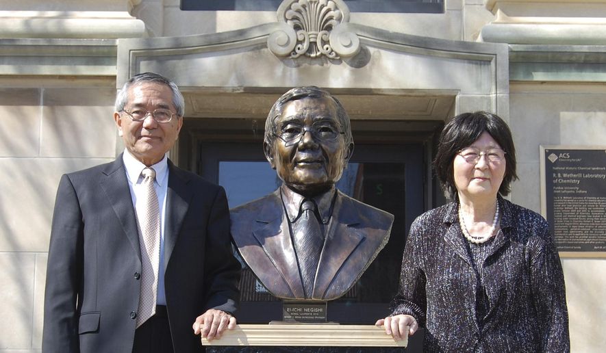 In this April 18, 2014, file photo, Nobel laureate and Purdue University professor Ei-ichi Negishi, left, stands with his wife Sumire after the unveiling of a bronze sculpture of him outside of Wetherill Laboratory of Chemistry on campus at Purdue University in West Lafayette, Ind. Sumire Negishi was found dead Tuesday, March 13, 2018, in a northern Illinois landfill after her 82-year-old husband was found wandering a road south of Rockford, Ill., police said. (Steve Scherer/Purdue University via AP)