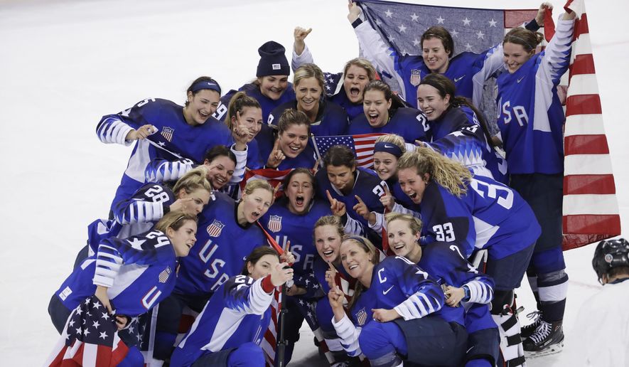 FILE - In this Feb. 22, 2018, file photo, the United States team celebrates winning the women&#x27;s gold medal hockey game against Canada at the 2018 Winter Olympics in Gangneung, South Korea. Women’s hockey players and the NHL believe one professional league instead of two is necessary to grow the sport in the aftermath of the U.S. winning gold at the Olympics. Currently the Canadian Women’s Hockey League and National Women’s Hockey League compete for players and attention.  (AP Photo/Matt Slocum, File)