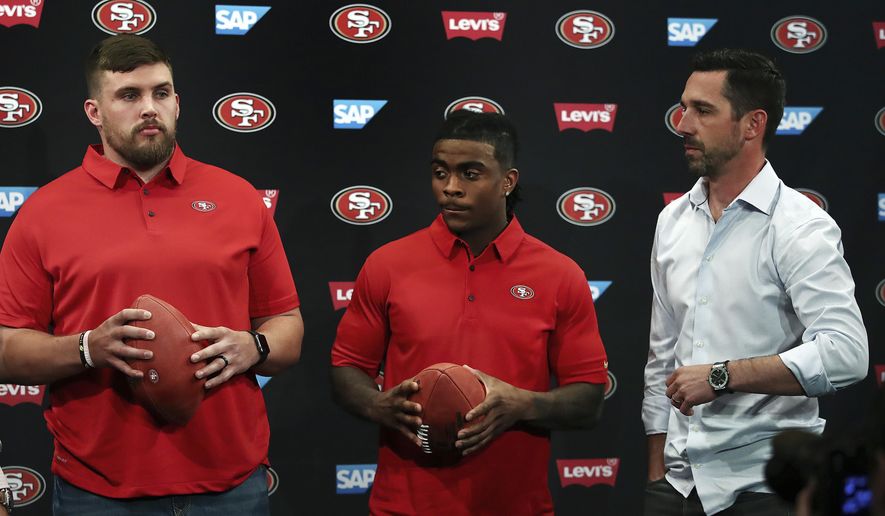 San Francisco 49ers coach Kyle Shanahan, right, stands with the NFL football team's newest players, Weston Richburg, left, and Jerick McKinnon, after a news conference Thursday, March 15, 2018, in Santa Clara, Calif. (AP Photo/Ben Margot)