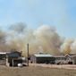Smoke from a wildfire, named the Carson Midway wildfire, billows behind homes in Hanover, Colo., Friday March 16, 2018. (Dougal Brownlie/The Gazette via AP)
