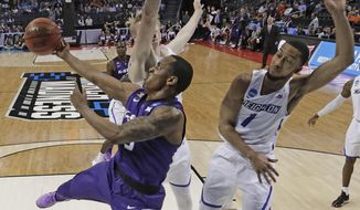 Kansas State&#39;s Barry Brown, left, drives against Creighton&#39;s Davion Mintz, right, during the first half of a first-round game in the NCAA men&#39;s college basketball tournament in Charlotte, N.C., Friday, March 16, 2018. (AP Photo/Gerry Broome)