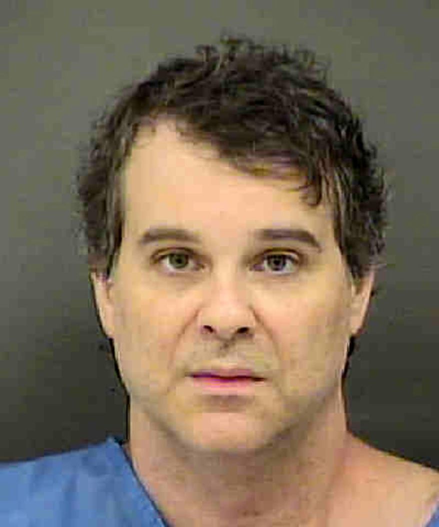 This March 15, 2018 photo provided by the Mecklenburg County Sheriff's Office shows Christian McCall at the Mecklenburg County jail in North Carolina. McCall, a banker suspected of killing a police officer and wounding three others after a domestic dispute two months ago, spent eight years in the Army and had a successful professional career making nearly $86,000 a year. The burst of unusual violence stunned family, who said they didn't see any signs of looming problems or a violent breakdown. (Charlotte Mecklenburg Police Department via AP)