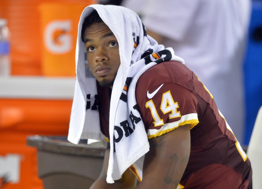 FILE - In this Aug. 13, 2015, file photo, Washington Redskins wide receiver Ryan Grant sits on the sideline during an NFL preseason football game against the Cleveland Browns in Cleveland. The Baltimore Ravens have withdrawn their contract offer to former Redskins wide receiver Ryan Grant after he failed his physical, Ravens general manager Ozzie Newsome said Friday, March 16, 2018. (AP Photo/David Richard, File)