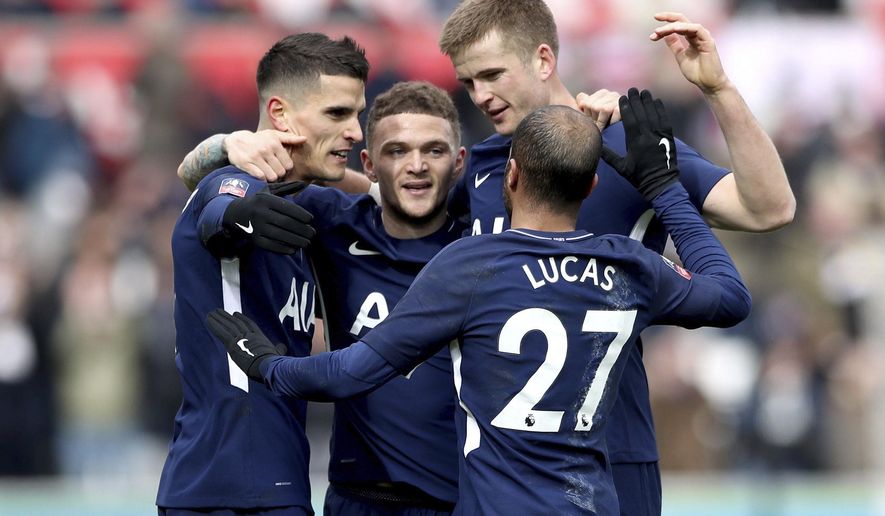Tottenham Hotspur&#39;s Erik Lamela, left, celebrates scoring his side&#39;s second goal of the game against Swansea City with teammates during the English FA Cup, quarterfinal soccer match at the Liberty Stadium, Swansea, Wales, Saturday March 17, 2018. (Nick Potts/PA via AP)