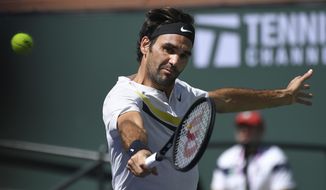 Roger Federer, of Switzerland, returns a shot against Borna Coric, of Croatia, during the semifinals of the BNP Paribas Open tennis tournament, Saturday, March 17, 2018, in Indian Wells, Calif. (AP Photo/Mark J. Terrill)