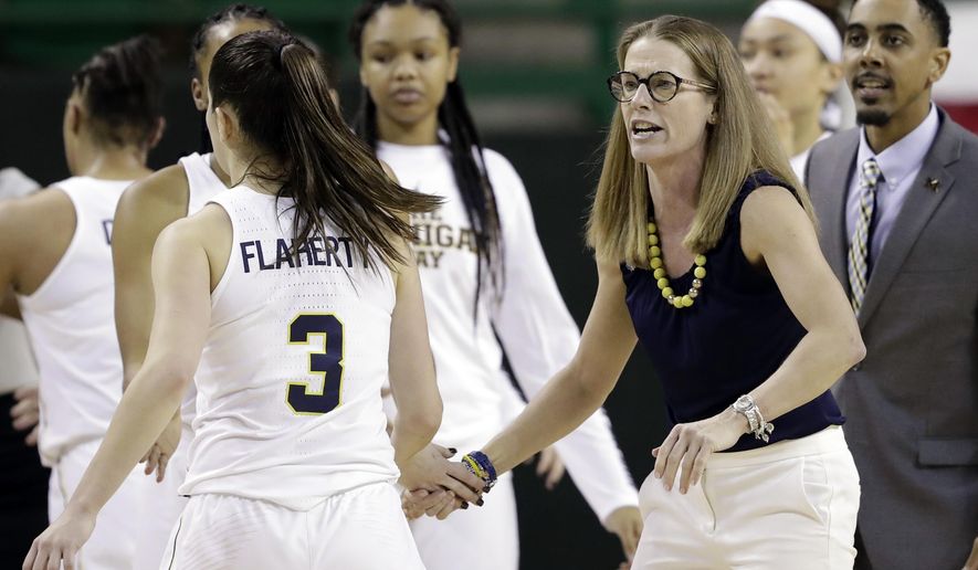 Michigan&#39;s Katelynn Flaherty (3) and the rest of the players are greeted at the bench by head coach Kim Barnes Arico, right, during a timeout in the second half of a first-round game against Northern Colorado at the NCAA women&#39;s college basketball tournament in Waco, Texas, Friday, March 16, 2018. (AP Photo/Tony Gutierrez)