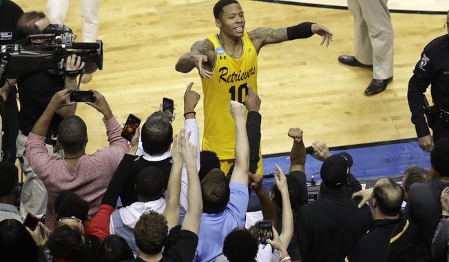 UMBC&#x27;s Jairus Lyles (10) celebrates with fans after the team&#x27;s 74-54 win over Virginia in a first-round game in the NCAA men&#x27;s college basketball tournament in Charlotte, N.C., Friday, March 16, 2018. (AP Photo/Chuck Burton)