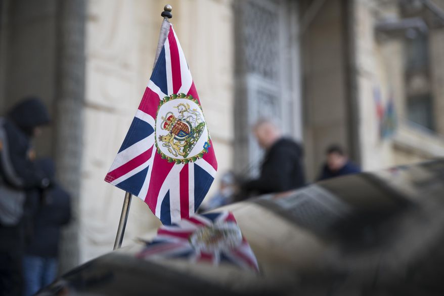 The British Union flag flies from the front of a car as British ambassador to Russia, Laurie Bristow attends a meeting at the Russian foreign ministry building in Moscow, Russia, Saturday, March 17, 2018. Russia's Foreign Ministry has summoned Bristow for talks in a heightening dispute over a nerve agent attack on a former spy in Britain. Russia is expected to announce the expulsion of some British diplomats in a retaliatory measure. (AP Photo/Pavel Golovkin)