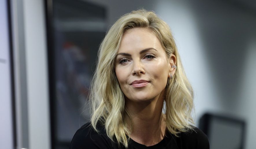 Actress Charlize Theron listens to a question during a news conference before the NASCAR Daytona 500 Cup series auto race at Daytona International Speedway in Daytona Beach, Fla., Sunday, Feb. 18, 2018. (AP Photo/Terry Renna) ** FILE **