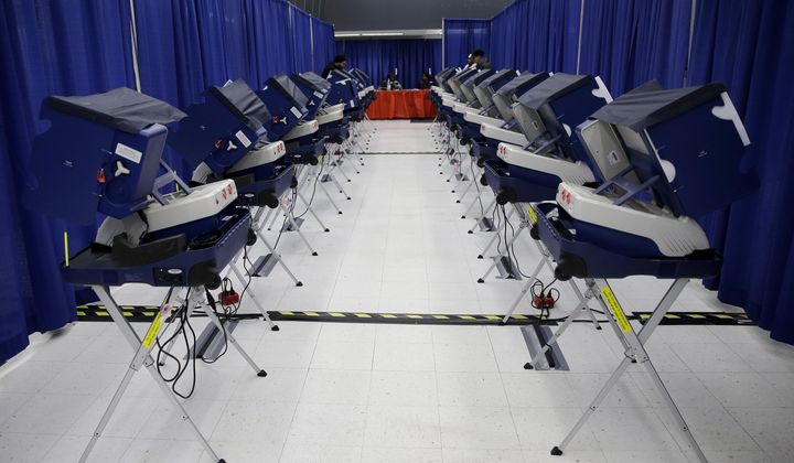 In this Tuesday, March 13, 2018 photo, voters cast their ballots in Illinois primary elections at the city&#x27;s new early voting super site in downtown Chicago. In Illinois, attempts by hackers in the summer of 2016 to alter voter registration information were ultimately unsuccessful, although voter data was viewed. (AP Photo/Kiichiro Sato)