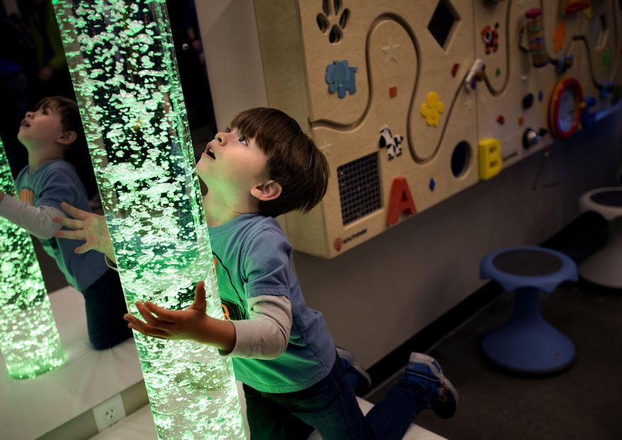 In this Wednesday, March 14, 2018 photo, Kylen Hair, 4, of Orem plays on the bubble tube in the new sensory room at the Vivint Smart Home Arena in Salt Lake City. Vivint Gives Back Director Holly Mero-Bench says the space is considered a therapy room since each component in the room is meant to “stimulate or calm a specific sense.” The room will be available to the public starting March 30. (Laura Seitz/The Deseret News via AP)