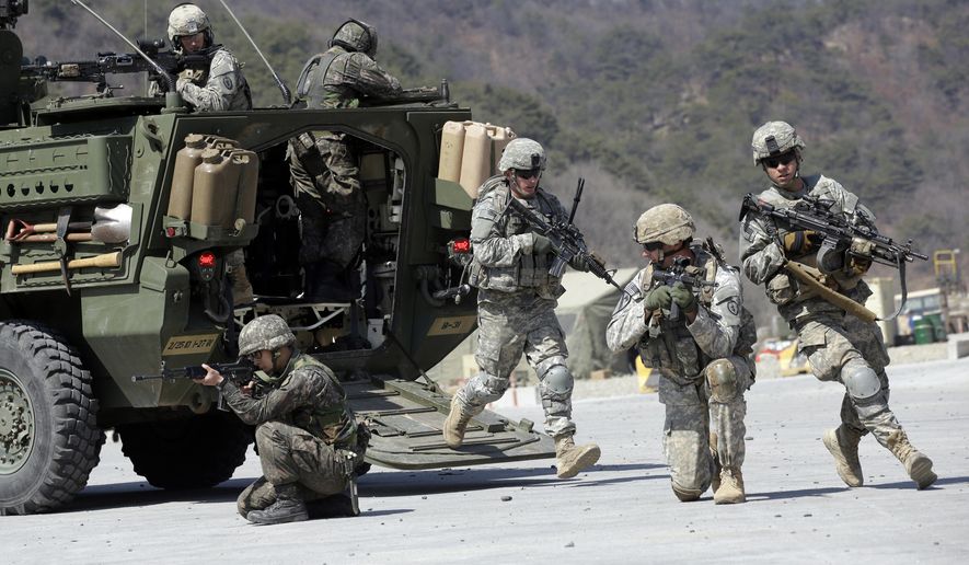 FILE - In this March 25, 2015, file photo, U.S. Army soldiers from the 25th Infantry Division&#x27;s 2nd Stryker Brigade Combat Team and South Korean soldiers take their position during a demonstration of the combined arms live-fire exercise as a part of the annual joint military exercise Foal Eagle between South Korea and the United States at the Rodriquez Multi-Purpose Range Complex in Pocheon, north of Seoul, South Korea. The Pentagon says the annual U.S.-South Korean military exercises that had been postponed for the Pyeongchang Winter Olympics will begin April 1. (AP Photo/Lee Jin-man, File)