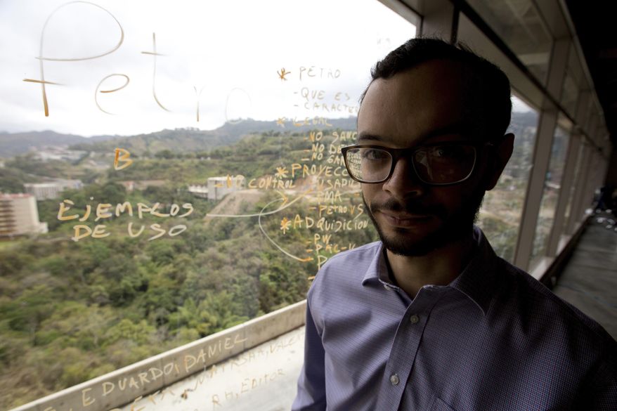 In this March 7, 2018 photo, Gabriel Jimenez poses for a portrait at his office in Caracas, Venezuela. Jimenez is the chief strategist of Venezuela’s government-backed cryptocurrency. He is also a former U.S. congressional intern who organized protests against the same administration he’s now helping to circumvent U.S. financial sanctions. (AP Photo/Fernando Llano)