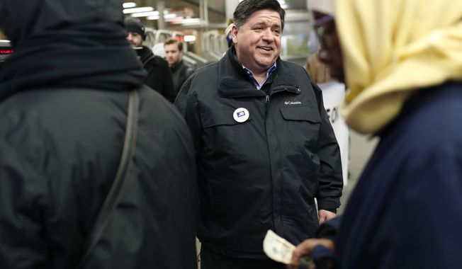 Illinois Democratic gubernatorial candidate J.B. Pritzker greets voters at the CTA Roosevelt Orange and Green Line station in Chicago on Election Day, Tuesday, March 20, 2018. (Jose M. Osorio/Chicago Tribune via AP)