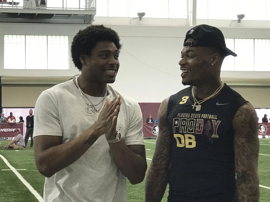 Former Florida State football defensive back Jalen Ramsey, left, who plays for the Jacksonville Jaguars, share some laughs with Derwin James during Florida State Pro Day, Tuesday March 20, 2018, in Tallahassee, Florida. (AP Photo/Joe Reedy)
