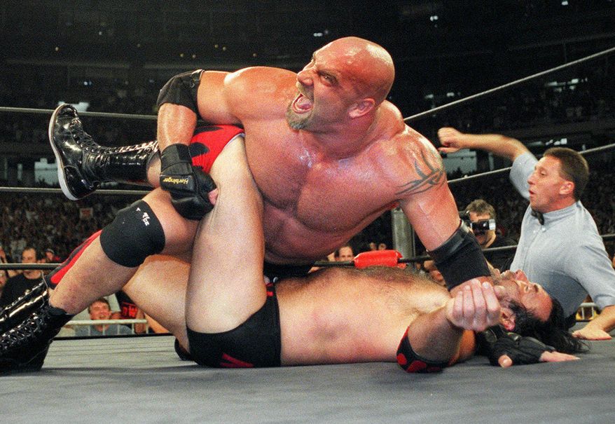 FILE - In this July 6, 1998, file photo, World Championship Wrestling heavyweight champion Bill Goldberg puts Scott Hall to the mat during a match in Atlanta. Bill Goldberg found his toughest tag-team partner yet. "The Goldbergs." Goldberg is set to star in Wednesday's, March 21, 2018, episode. But the wrestling great has a bigger date ahead when he's inducted into the WWE Hall of Fame on WrestleMania weekend. (AP Photo/Erik S. Lesser)