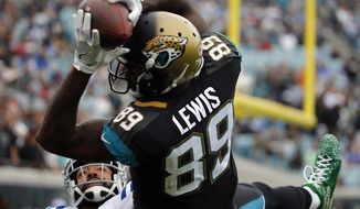 FILE - In this Dec. 3, 2017, file photo, Jacksonville Jaguars tight end Marcedes Lewis (89) makes a catch over Indianapolis Colts safety Matthias Farley, left, for a 2-point conversion during the second half of an NFL football game, in Jacksonville, Fla. Jaguars tight end Marcedes Lewis says he has been released after 12 seasons with the team. Lewis told The Associated Press on Tuesday, March 20, 2018, he got the news from his agent and feels “disrespected” by the timing of the move.  It came a week after free agency began. He says, “I wish they would have done it sooner. I think I deserved a little better than this.”(AP Photo/Stephen B. Morton, File)