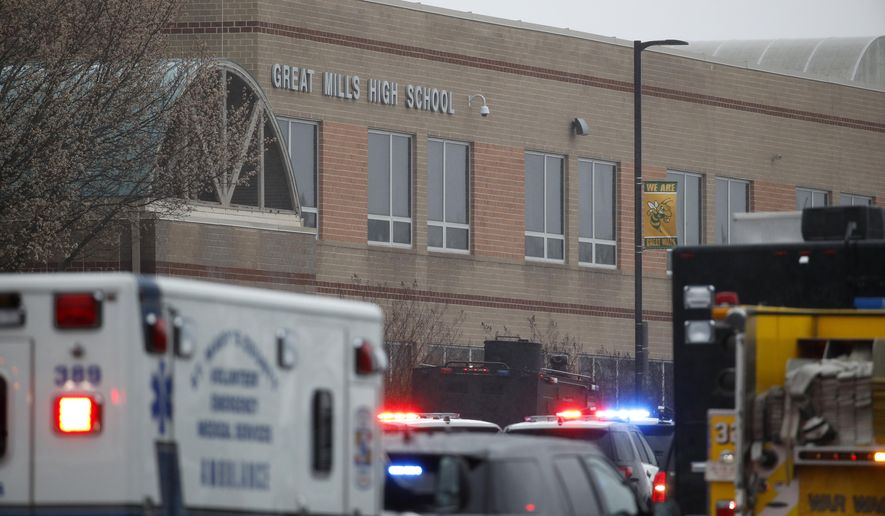 Deputies, federal agents and rescue personnel, converge on Great Mills High School, the scene of a shooting, Tuesday morning, March 20, 2018 in Great Mills, Md. The shooting left at least three people injured including the shooter. (AP Photo/Alex Brandon  )