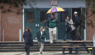 Teachers and school employees depart Great Mills High School, the scene of a shooting, Tuesday, March 20, 2018 in Great Mills, Md.  A teenager wounded a girl and a boy inside his Maryland high school Tuesday before an armed school resource officer was able to intervene, and each of them fired one more round as the shooter was fatally wounded, a sheriff said.  St. Mary&#39;s County Sheriff Tim Cameron said the student with the handgun was declared dead at a hospital, and the other two students were in critical condition. He said the officer was not harmed.  (AP Photo/Alex Brandon)