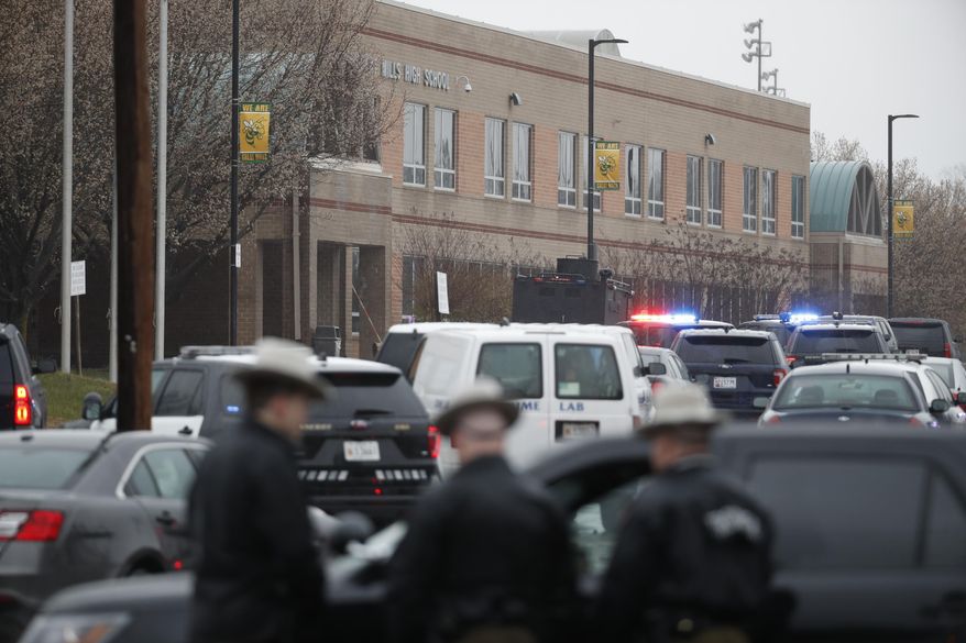Deputies and federal agents converge on Great Mills High School, the scene of a shooting, Tuesday morning, March 20, 2018 in Great Mills, Md. The shooting left three people injured including the shooter. Authorities said the situation was "contained." (AP Photo/Alex Brandon )