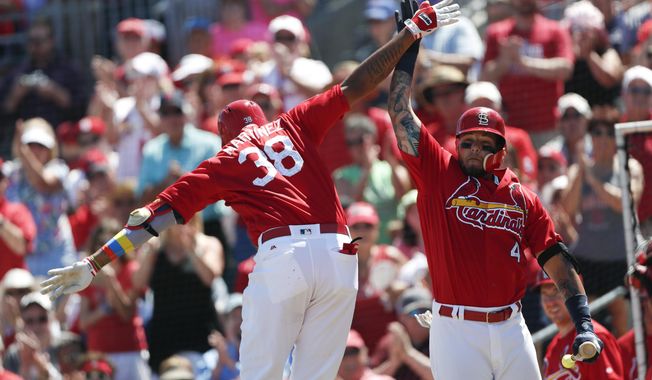 St. Louis Cardinals&#x27; Jose Martinez (38) celebrates with Yadier Molina (4) after hitting a home run in the fourth inning of a spring training baseball game against the Washington Nationals, Sunday, March 18, 2018, in Jupiter, Fla. (AP Photo/John Bazemore)