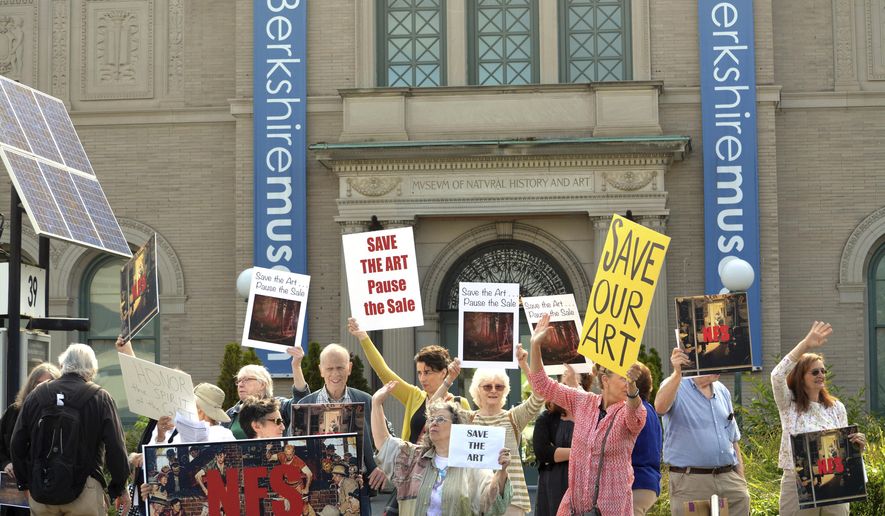 In a Saturday, Aug. 12, 2017 file photo, people opposed to the selling of The Berkshire Museum&#x27;s art to fund an expansion and endowment, protest in front of museum in Pittsfield, Mass. A judge on Massachusetts’ highest court is stepping into a fight over the proposed sale of works of art by the cash-strapped museum. A hearing before a single justice of the Supreme Judicial Court is set for Tuesday, March 20, 2018 in Boston. (Gillian Jones/The Berkshire Eagle via AP, File)