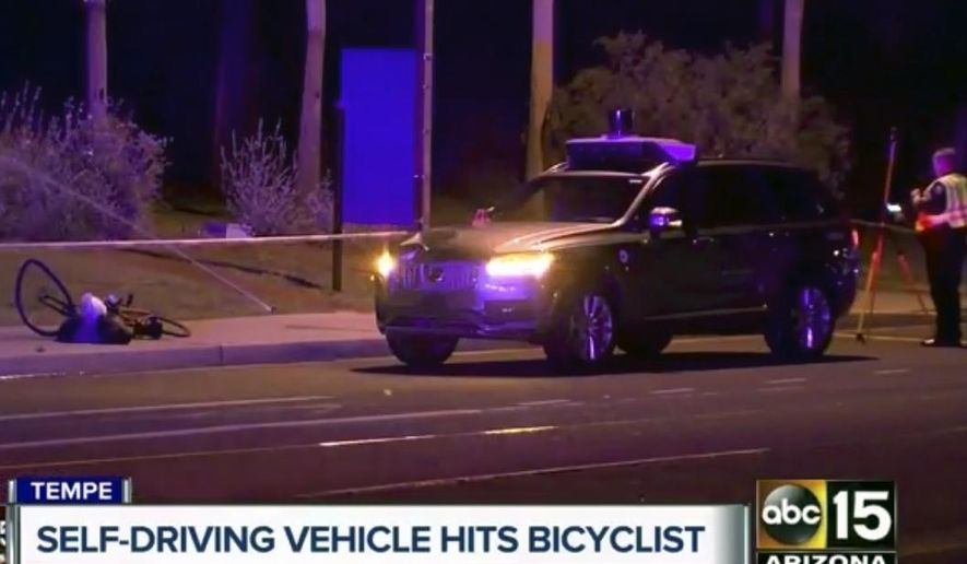 This March 19, 2018, still image taken from video provided by ABC-15, shows investigators at the scene of a fatal accident involving a self driving Uber car on the street in Tempe, Ariz. Police in the city of Tempe said Monday, March 19, 2018, that the vehicle was in autonomous mode with an operator behind the wheel when the woman walking outside of a crosswalk was hit. (ABC-15.com via AP)