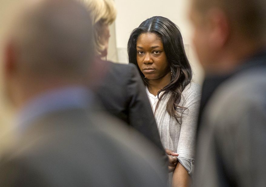 Tiara Burnett appears in court to waive a preliminary examination on a perjury charge at the Kent County Courthouse in Grand Rapids, Mich., on Tuesday, March 20, 2018. Burnett, who is the fiancee of Quinn James, faces a life offense for statements provided to Assistant Kent County Prosecutor Kellee Koncki during an investigative-subpoena procedure related to the death of Mujey Dumbuya, the Kentwood teen found dead in Kalamazoo, after accusing James of rape. (Cory Morse /The Grand Rapids Press via AP)