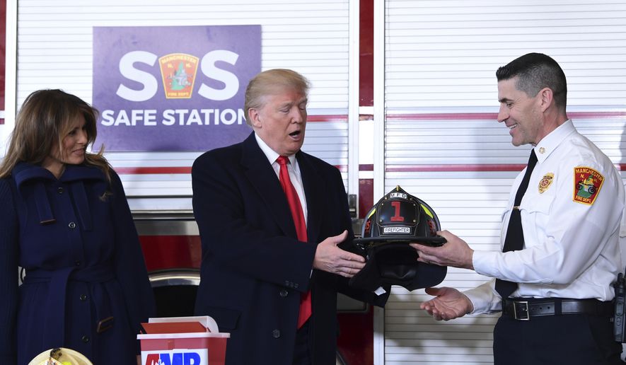 President Donald Trump, center, receives a helmet from Manchester City Fire Chief Daniel Goonan, right, as first lady Melania Trump, left, watches during a visit to the Manchester Central Fire Station in Manchester, N.H., Monday, March 19, 2018. Trump is in New Hampshire to unveil more of his plan to combat the nation's opioid crisis. (AP Photo/Susan Walsh)
