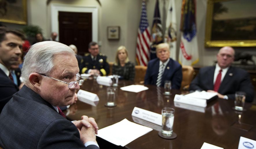 From back center clockwise; Homeland Security Secretary Kirstjen Nielsen, President Donald Trump, Immigration and Customs Enforcement Deputy Director Thomas Homan, Attorney General Jeff Sessions and Sen. Tom Cotton, R-Ark., listen to law enforcement officers speak during a roundtable talks on sanctuary cities hosted by Trump in the Roosevelt Room of the White House, in Washington, Tuesday, March 20, 2018. (AP Photo/Manuel Balce Ceneta)