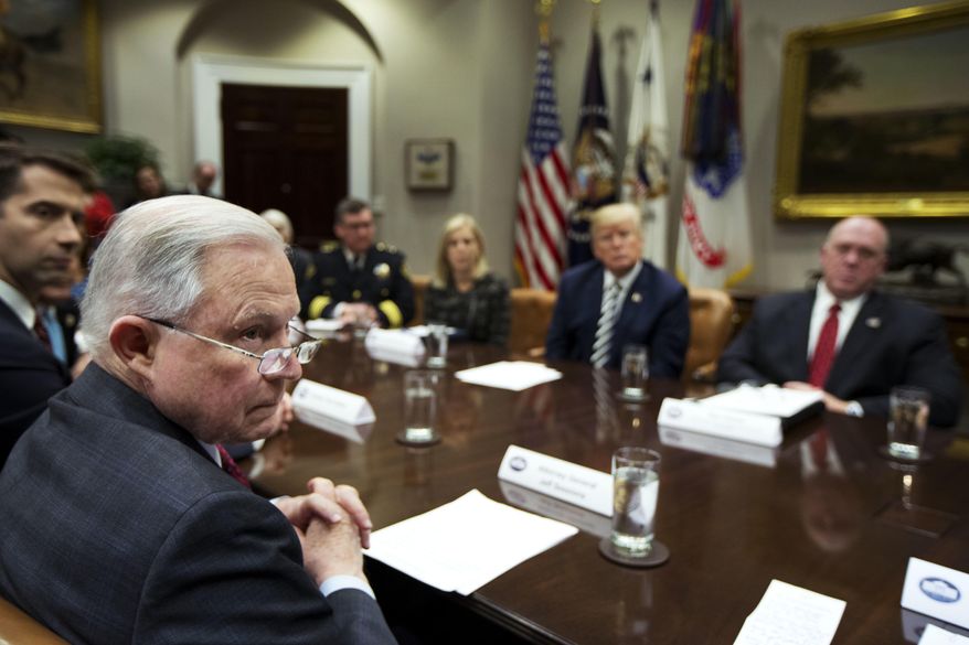 From back center clockwise; Homeland Security Secretary Kirstjen Nielsen, President Donald Trump, Immigration and Customs Enforcement Deputy Director Thomas Homan, Attorney General Jeff Sessions and Sen. Tom Cotton, R-Ark., listen to law enforcement officers speak during a roundtable talks on sanctuary cities hosted by Trump in the Roosevelt Room of the White House, in Washington, Tuesday, March 20, 2018. (AP Photo/Manuel Balce Ceneta)