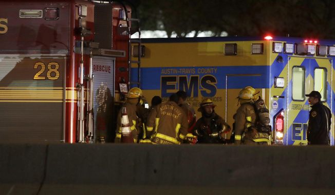Firefighters stage near the area where a suspect in a series of bombing attacks in Austin blew himself up as authorities closed in, early Wednesday, March 21, 2018, in Round Rock, Texas. A suspected arsonist stabbed an Austin firefighter (not pictured) as crews battled blazes set alongside Interstate 35 on Monday. (AP Photo/Eric Gay)