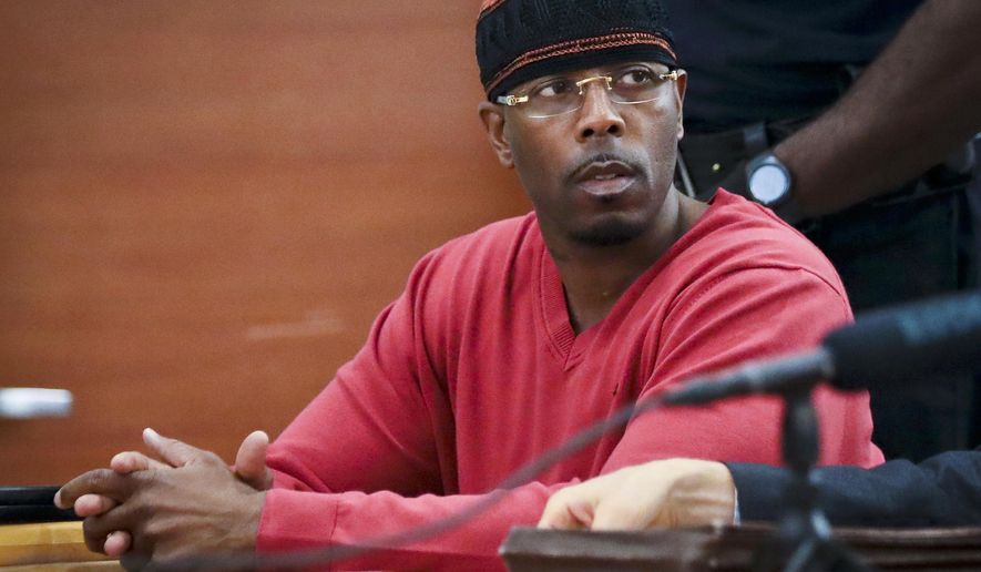 FILE - In this May 5, 2017, photo file photo, Calvin Buari listens during a hearing at Bronx Criminal Court to vacate his double murder conviction, in New York. Prosecutors dropped charges Wednesday, March 21, 2018, against Buari who spent 22 years in prison for a double killing before new witnesses came forward and his conviction was overturned. (AP Photo/Bebeto Matthews, File)