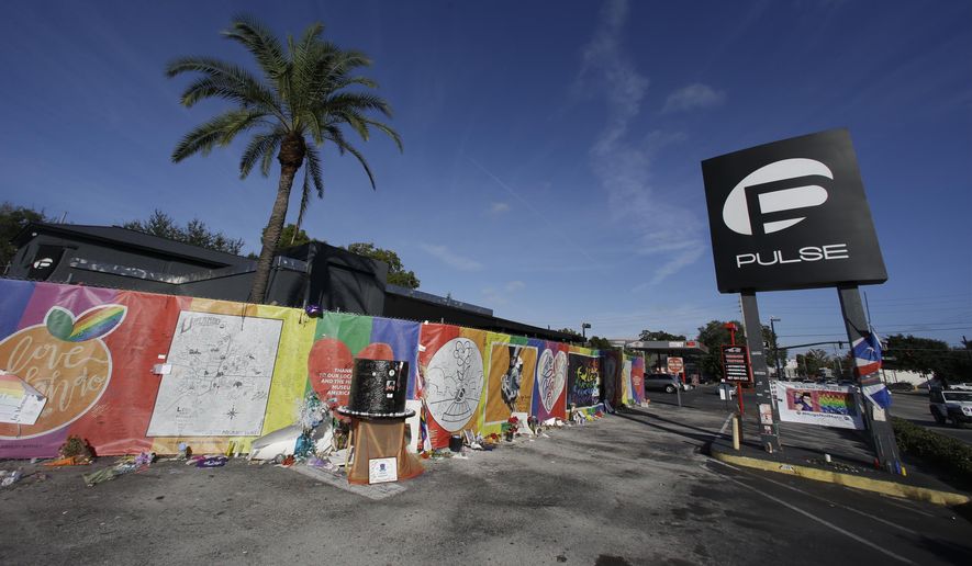 In this Nov. 30, 2016, file photo, artwork and signatures cover a fence around the Pulse nightclub, scene of a mass shooting, in Orlando, Fla.  Jurors in the federal trial of  Noor Salman, the Pulse nightclub gunman&#39;s widow, have gotten a look inside his Florida condo through crime scene photos taken as FBI agents searched the home. They also saw some of her husband Omar Mateen&#39;s web browsing history Tuesday, March 20, 2018, including beheading videos created by the Islamic State group Mateen had pledged allegiance to. Salman is accused of aiding and abetting her husband in the 2016 attack that left 49 people dead. (AP Photo/John Raoux)