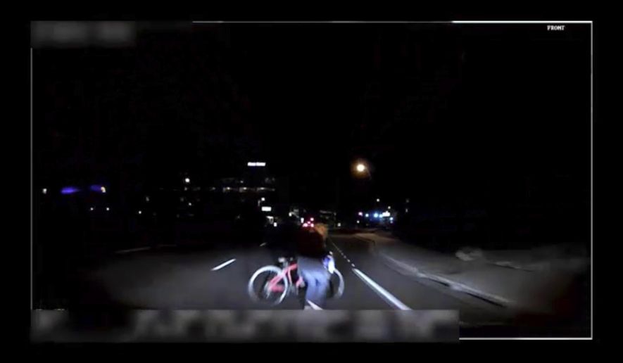 This image made from video Sunday, March 18, 2018, of a mounted camera provided by the Tempe Police Department shows an exterior view moments before an Uber SUV hit a woman in Tempe, Ariz. Video of a deadly self-driving vehicle crash in suburban Phoenix shows the pedestrian walking from a darkened area onto a street just moments before the crash. (Tempe Police Department via AP)