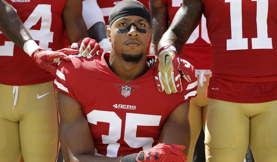 In this Sept. 10, 2017, file photo, San Francisco 49ers safety Eric Reid (35) kneels in front of teammates during the playing of the national anthem before an NFL football game against the Carolina Panthers, in Santa Clara, Calif. Reid says his Christian faith is the reason why he joined former teammate Colin Kaepernick in kneeling for the anthem. (AP Photo/Marcio Jose Sanchez, File)