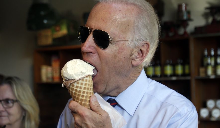 Joe Biden enjoys an ice cream cone after a campaign rally for Oregon U.S. Sen. Jeff Merkley in Portland, Ore., Wednesday, Oct. 8, 2014. Biden was in Portland campaigning for Merkley who is being challenged by Republican Monica Wehby.(AP Photo/Don Ryan)