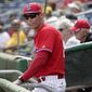 FILE - In this March 1, 2018, file photo, Philadelphia Phillies manager Gabe Kapler watches from the dugout before a baseball spring exhibition game against the New York Yankees, in Clearwater, Fla. Kapler plans to flip-flop outfielders in the middle of an inning to put his best defensive player in position where the spray charts indicate a batter is most likely to hit the ball. (AP Photo/Lynne Sladky, File)