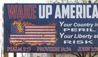 This Wednesday, March 21, 2018, file photo shows one of two billboards displaying the Ten Commandments and a flaming American flag which Wayne Wallace installed without proper permits in Brookhaven, Miss Wallace is required to move the signs further back from their current position from state highway 51, and that&#39;s OK with Brookhaven Mayor Joe Cox, who says the city was never &amp;quot;against the word of God.&amp;quot; (AP Photo/Rogelio V. Solis) ** FILE **