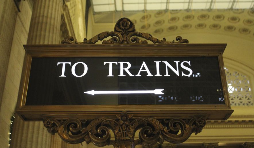In this Nov. 12, 2017 photos, the &amp;quot;To Trains&amp;quot; sign in the Great Hall of Chicago Union Station directs passengers to loading platforms. (AP Photo/Paul Davenport)