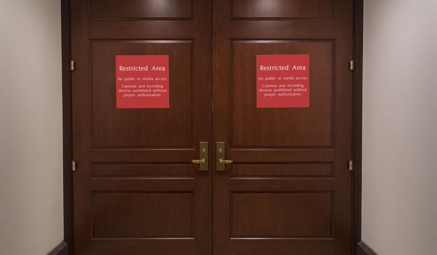 The doors to a secure are where the House Intelligence Committee meets are shut as the GOP majority prepares to end its participation in the Russia probe, officially shutting down the panel's investigation, on Capitol Hill in Washington, Thursday, March 22, 2018. (AP Photo/J. Scott Applewhite)