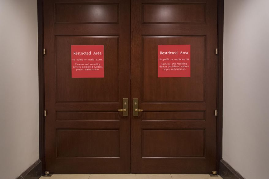 The doors to a secure are where the House Intelligence Committee meets are shut as the GOP majority prepares to end its participation in the Russia probe, officially shutting down the panel's investigation, on Capitol Hill in Washington, Thursday, March 22, 2018. (AP Photo/J. Scott Applewhite)