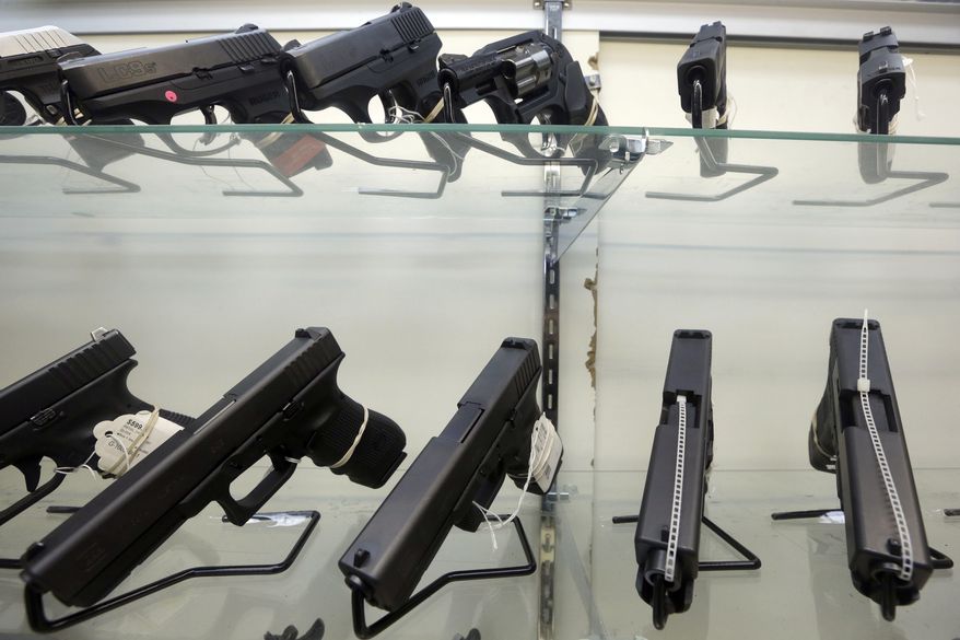 This June 29, 2016, file photo shows guns on display at a gun store in Miami. (Associated Press) ** FILE **