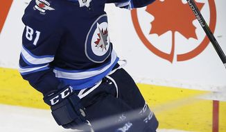 Winnipeg Jets left wing Kyle Connor celebrates scoring the game-winning goal against the Anaheim Ducks in overtime of an NHL hockey game Friday, March 23, 2018, in Winnipeg, Manitoba. (John Woods/The Canadian Press via AP)