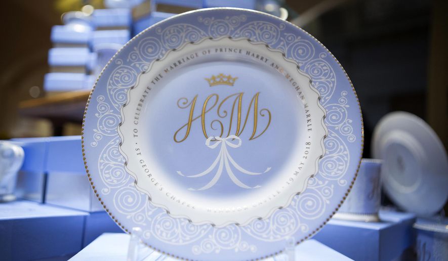 A plate with the initials H and M which forms part of the new official range of china to celebrate the future marriage of Britain's Prince Harry and Meghan Markle is displayed in The Queen's Gallery shop at Buckingham Palace, London, Wednesday March 21, 2018. (Rick Findler/PA via AP)