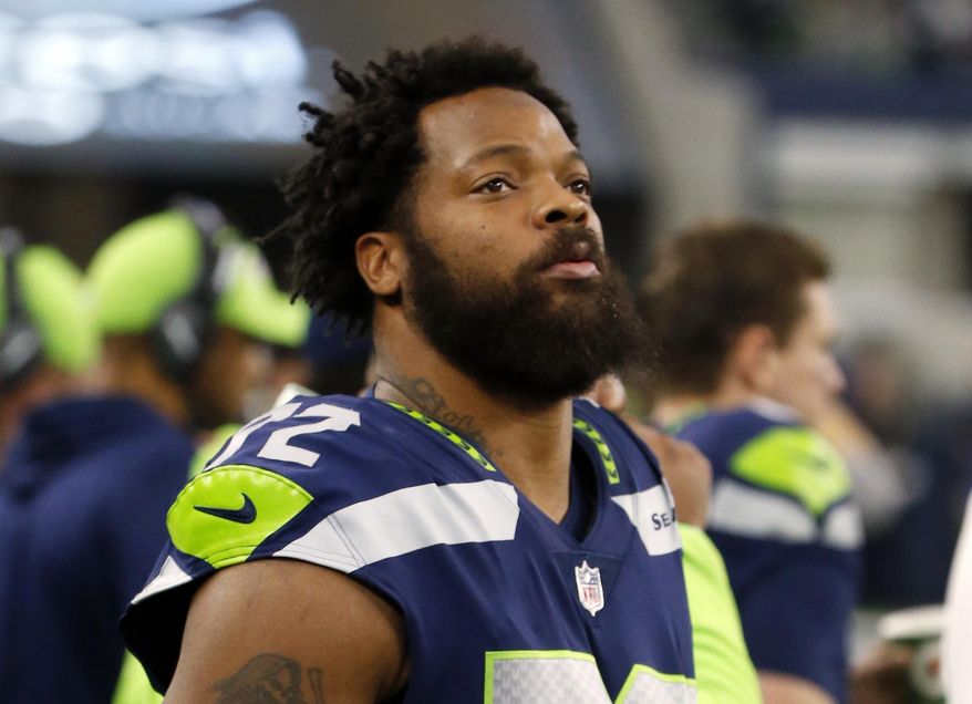 FILE - In this Dec. 24, 2017, file photo, Seattle Seahawks defensive end Michael Bennett (72) watches his team play the Dallas Cowboys during an NFL football game in Arlington, Texas. A Harris County, Texas, grand jury on Friday, March 23, 20187, indicted Philadelphia Eagles defensive end Michael Bennett on a felony count of injury to the elderly for injuring a 66-year-old paraplegic who was working at NRG Stadium in Houston to control access to the field at Super Bowl 51, prosecutors said. The Eagles earlier this month acquired Bennett from the Seahawks.  (AP Photo/Michael Ainsworth, File)
