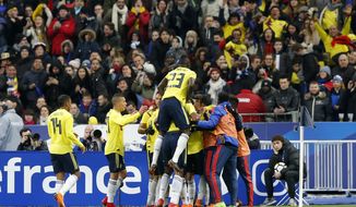 Teammates congratulate Colombia&#39;s Radamel Falcao after he scored his side second goal during a friendly soccer match between France and Colombia in Saint-Denis, outside Paris, Friday March 23, 2018. (AP Photo/Michel Euler)
